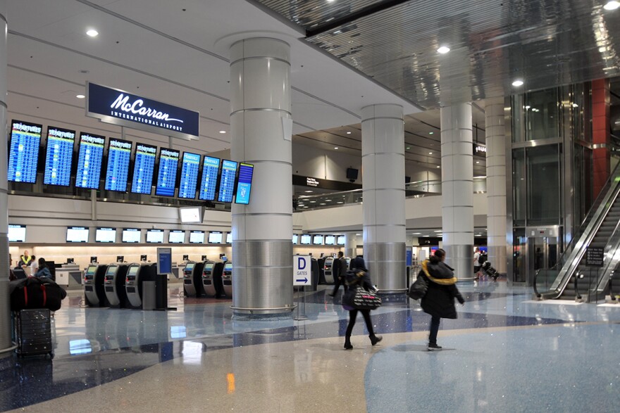 The ticketing terminal at Harry Reid International Airport before the signs were changed. A sign above the arrivals and departure information reads, "McCarran International Airport."