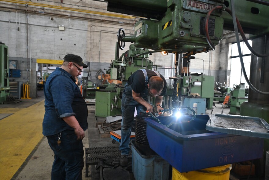 Mechanics at the Steamtown National Historic Site work on parts for the steam engine 26.