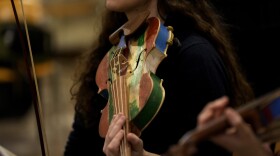 A woman member of the 'Sea Orchestra' rehearses with violin made from the wood of wrecked immigrants' boats in Milan, northern Italy, Saturday, Feb. 10, 2024. Inmates at Milan's maximum security prison Opera took the wood of wrecked boats sailed by migrants across the Sicily Channel to craft the musical instruments that the 'Sea Orchestra' used during their debut at La Scala Opera House in Milan on Monday, Feb. 12, 2024. The violins, violas and cellos played by the Orchestra of the Sea in its debut performance Monday at Milan's famed Teatro all Scala carry with them tales of hardship. (AP Photo/Antonio Calanni)