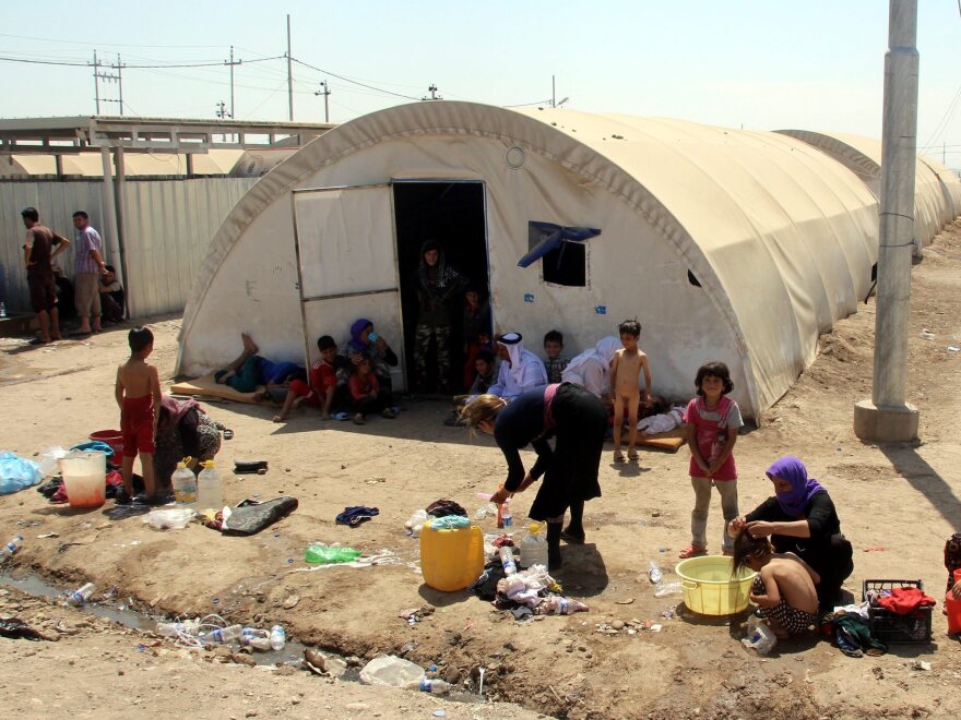 Yazidi women wash their children at a refugee camp near the Iraqi border crossing of Zakho in August.