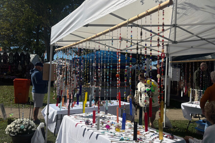 Art bead pieces hang from a tent.