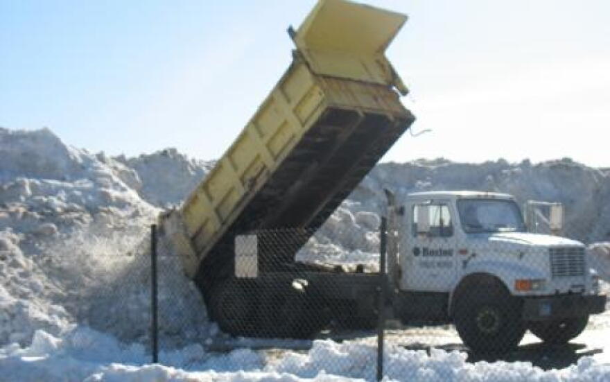 Dump truck in Boston adds a pile of snow to one of the city's \"snow farms\"