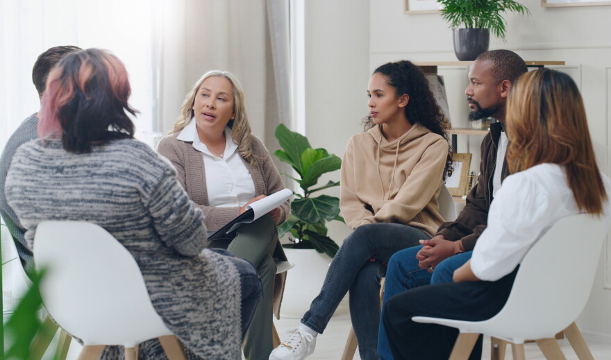 Counseling, group and psychology discussion with group of diversity people in therapy for depression, stress and anxiety. Men and women healing during psychologist meeting talking about mental health.