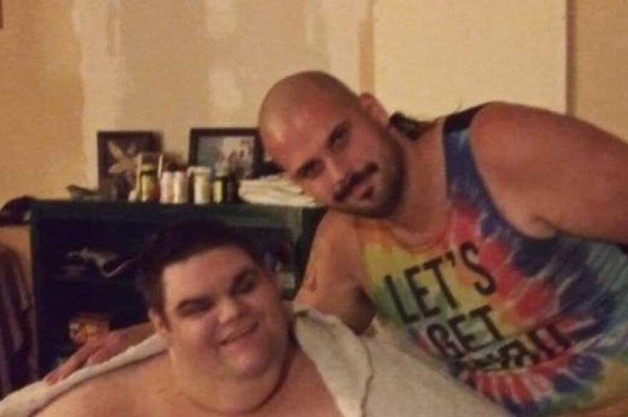 Danny Duncan, left, and his older brother Brandon, right, pose for a picture at their home in Spencer, Indiana. Danny has a severe form of autism, and before the start of the COVID-19 pandemic went to a day program at Stone Belt, a Bloomington nonprofit.