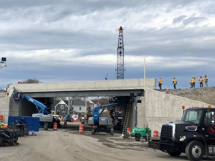 Workers move a slab into place as part of the project that closed a section of I-295 in Portland over the weekend.