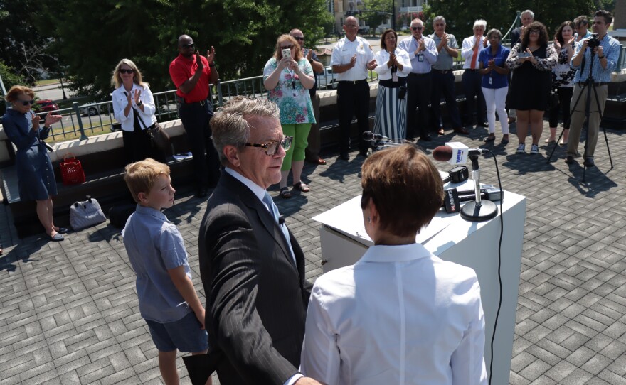 Evansville Mayor Lloyd Winnecke embraces wife Carol McClintock following a news conference Monday where he officially announced he'd not be running again. Winnecke first ran in 2011 and said it was time to move on and spend more time with family such as grand son Oliver (at podium.)