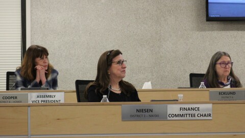From left, Kelly Cooper, Lenora Niesen and Cindy Ecklund participate in a borough assembly meeting on Tuesday, Feb. 3, 2026 in Soldotna, Alaska.