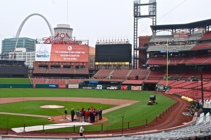 The grounds crew works on the field at Busch Stadium last week. Construction was still under way on the Budweiser Terrace, a new social gathering area in the upper right field seating sections. It will feature lounge seating, standing areas and two bars. 