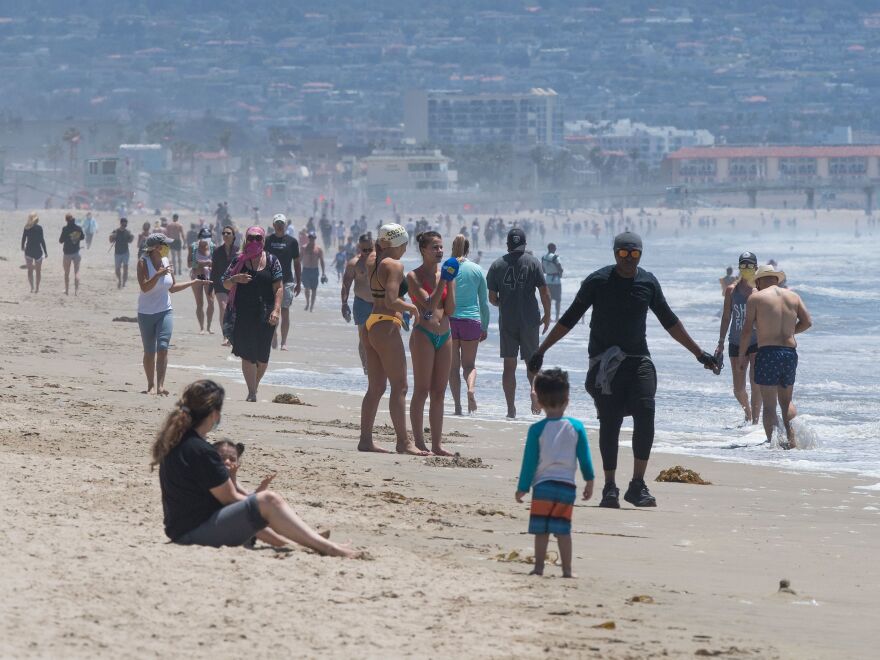 Californians enjoy the Manhattan and Hermosa beaches on Wednesday, the first day that Los Angeles County allowed beaches to reopen after a six-week closure during the coronavirus pandemic.