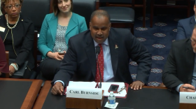 Principal Carl Burnside speaking before members of Congress