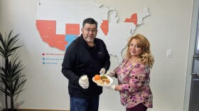 Chicanos Por La Causa employees Michael Lujan, holding the milk, and Blanca Valled, holding the dish, are showing the kind of food available to children through the Chicanos Por La Causa reimbursement program.