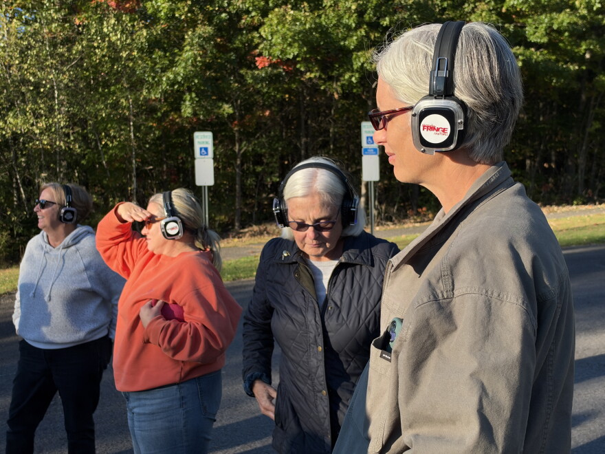 Participants of the 'Hazardous Local Impacts of AI Data Centers' bus tour wear headphones meant for a silent disco at Ed Staback Park in Archbald.