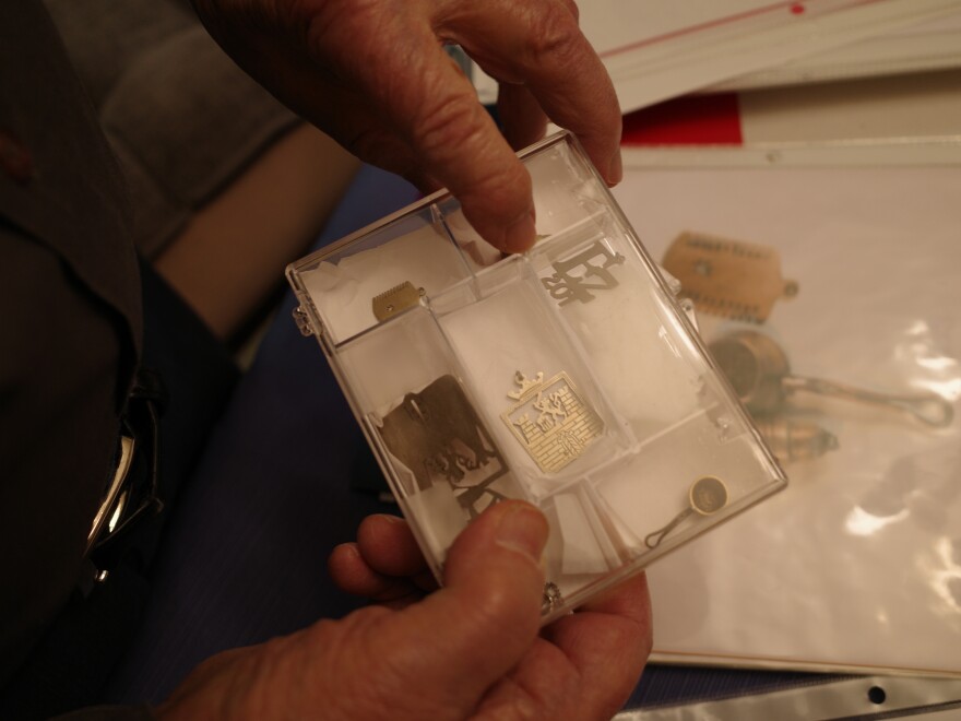 Vladimir Munk has saved jewelry he had made inside Terezin, a concentration camp north of Prague. He says the most popular was item was Terezin's coat of arms, center, which he had made for a girl he met there named Kitty, who would later become his wife of 66 years.