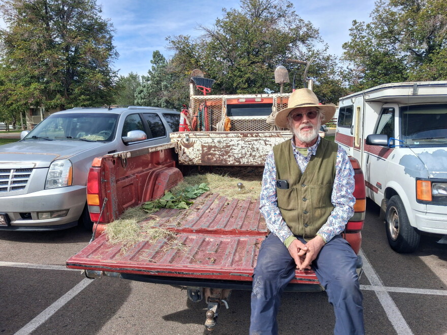 David Temple sits in an empty truck bed after handing out trees at the Cortez Public Library.