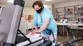 Oklahoma City resident Eugenia Gay Scanlon fed her ballot into an election machine on Feb. 8, 2022.