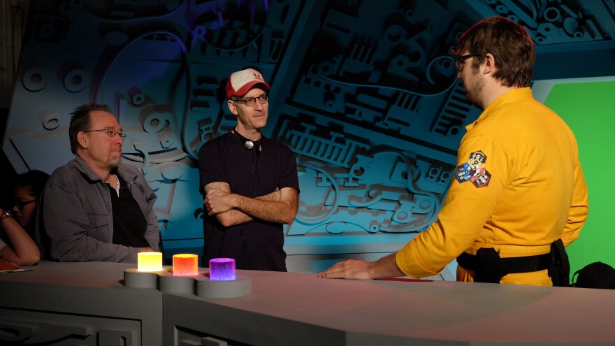 Hodgson and writer/producer Robert Cohen check in with Ray on the set of the new <em>Mystery Science Theater 3000.</em>
