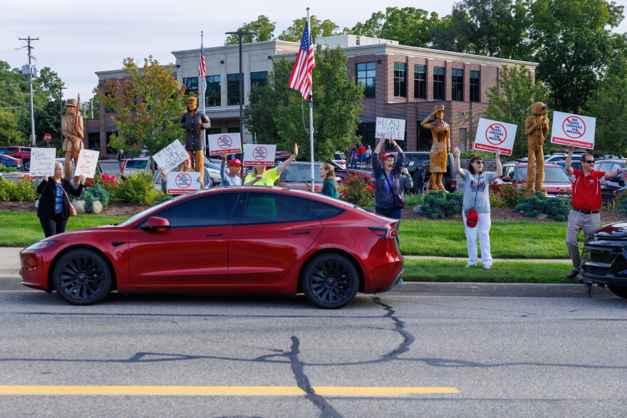 Community members protest potential data center developments in Mason, Mich., before a town hall meeting with city officials on Sept. 14, 2026.