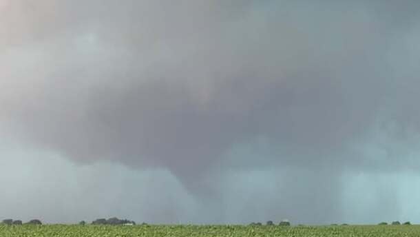 A tornado forms over a field. 
