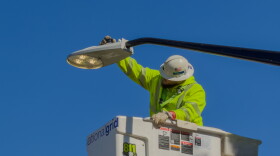 A National Grid employee turns on a street light that has just been replaced on Memorial Drive as part of Buffalo's City of Light initiative.