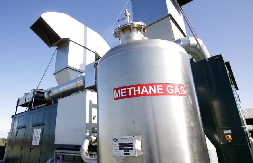 In this Wednesday, Nov. 23, 2016, photo, is the methane digester at the New Hope Dairy in Galt, Calif. Gov. Jerry Brown signed legislation in September that for the first time regulates heat-trapping gases from livestock operations and landfills. New Hope Dairy, which has about 1,500 cows, installed the $4 million digester in 2013, thanks to a state grant and a partnership with the local utility. The digester takes the methane gas, collected from the raw cow manure held in a 1 million gallon tank, to generate renewable power for the grid.