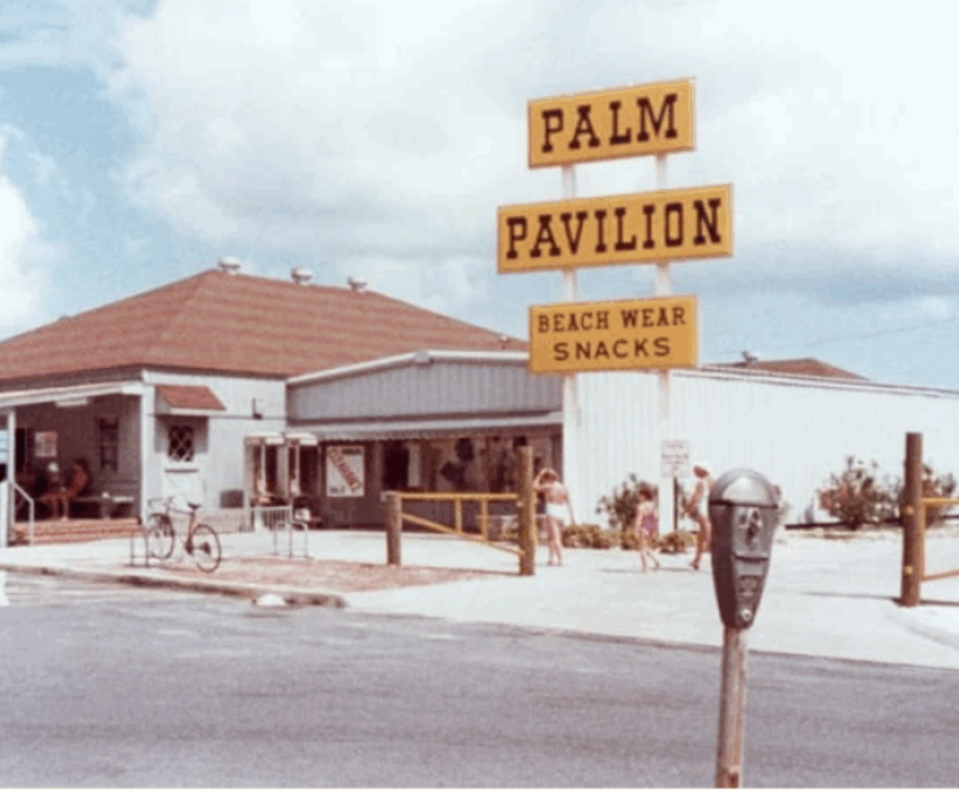 Older photo shows a building with a large yellow Palm Pavilion sign