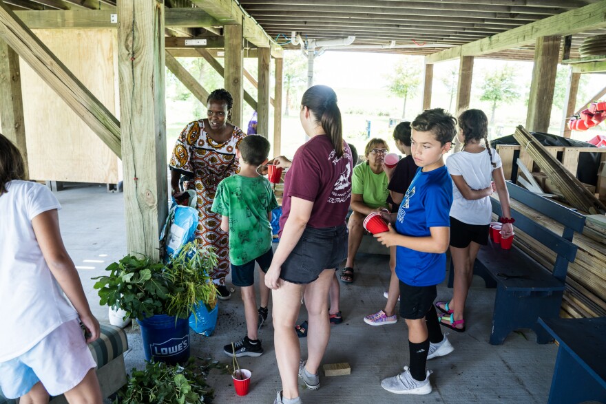 Campers learn about local plants and receive plant trimmings to take home from Tulane Professor Jelagat Cheruiyot.