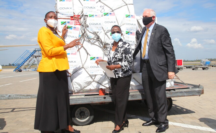 On July 24, Tanzanian Minister for Health Dr. Dorothy Gwajima (left) welcomes the first shipment of COVID-19 vaccines at the Dar es Salaam airport. She had previously endorsed a drink made from garlic, ginger and lemons as a treatment for the virus. She's standing with Foreign Affairs Minister Liberata Mulamula (center) and U.S. Ambassador to Tanzania Donald Wright.
