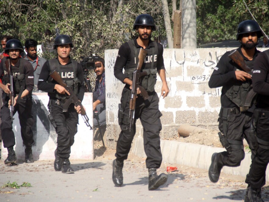 Pakistani police respond outside the Chinese consulate after an armed attack on Nov. 23.