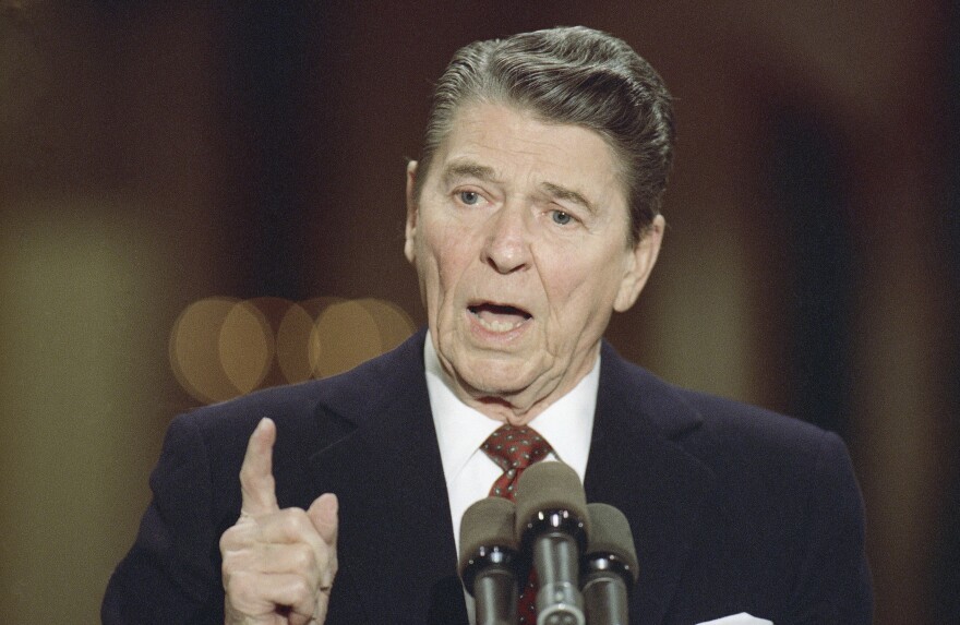 Former President Ronald Reagan speaks during a news conference in the East Room of the White House.