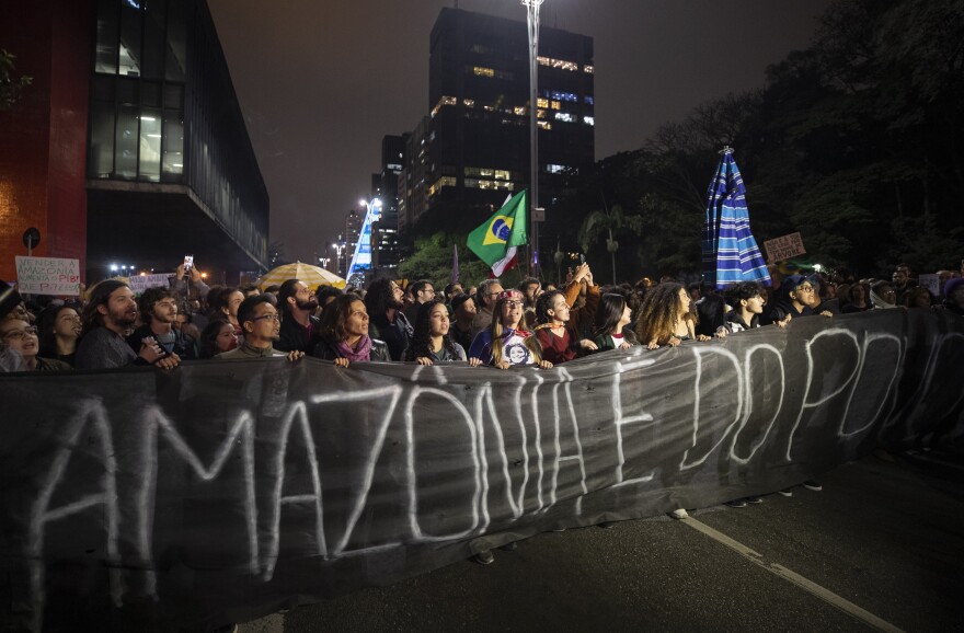 Demonstrators march on Friday in São Paulo, Brazil, holding a banner with a message that reads in Portuguese: "The Amazon belongs to the people." Brazilians staged protests across the country throughout the weekend demanding action to combat the fires in the Amazon.