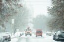 Vehicles slowly make their way over snow-covered, slick Shaw Boulevard during a winter storm on Monday, Dec. 1, 2025, in St. Louis’ Shaw neighborhood.
