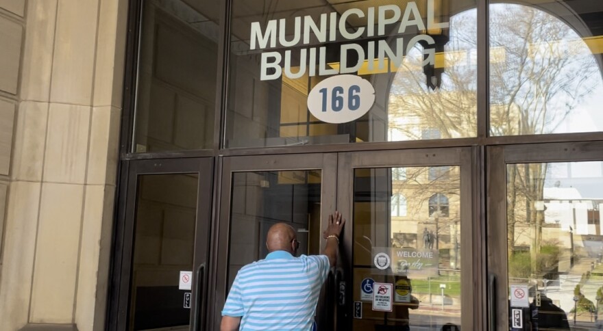 Rev. Stacey Jenkins prays at city municipal building