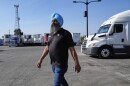 Harsimran Singh, owner of Gillson Trucking, walks through his lot in Stockton, Calif., Wednesday, Sept. 3, 2025.  
