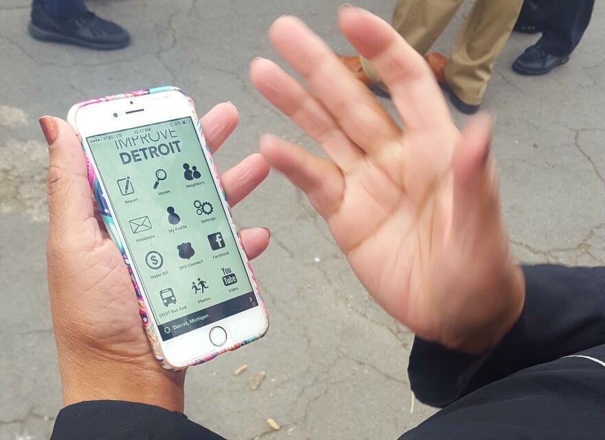 A Detroit resident uses the Improve Detroit mobile app.