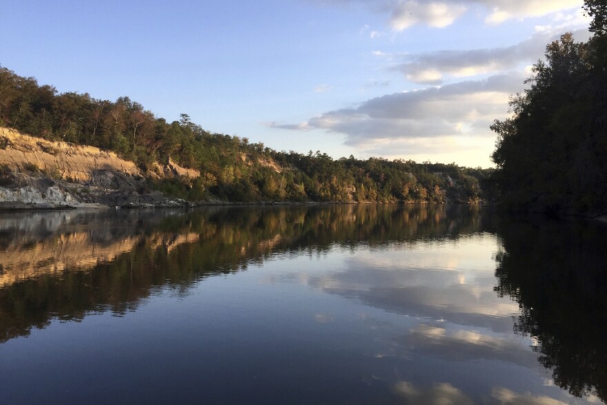 The sun sets over a river