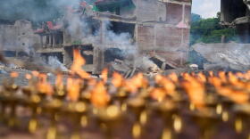Lamps burn as Buddhist monks perform rituals and prayers for victims of the recent flash floods in the Dhunge area of district Nuwakot, Nepal, Monday, Sept. 7, 2026. (Niranjan Shrestha/AP)