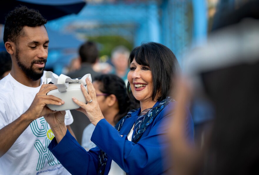 Grand Valley State University President Philomena V. Mantella prepares to experience virtual reality technology.