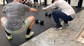 Coach Austin Haines shows correct form to a young participant of Expanding Horizons at the Circleville Juvenile Corrections Facility.