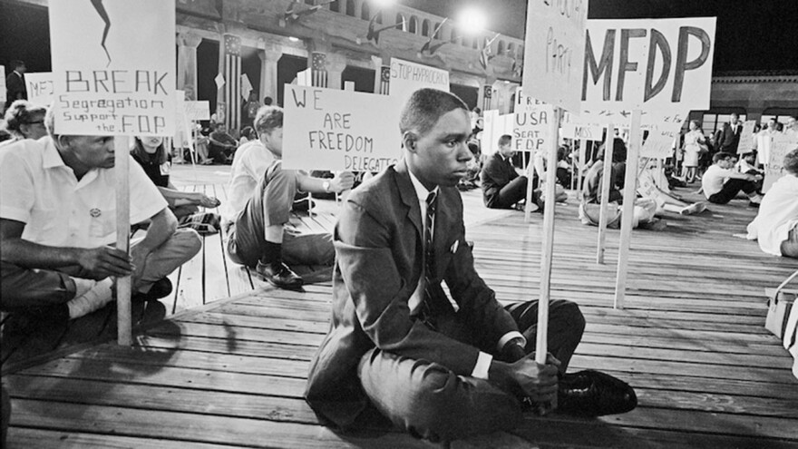 Protestors with signs sitting