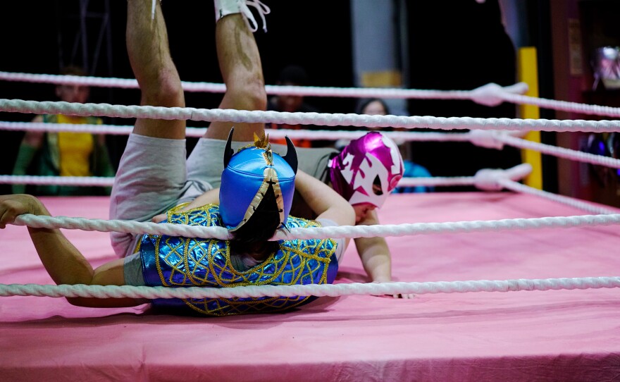Max Contreras, wearing a pink mask, tackles to the ground Joseph Quick. They have been practicing five nights per week during February and the beginning of March under Adam Flores, the play director, and Brandon Riley, their movement coach. This is their last tech rehearsal. Columbia, MO. March 07, 2023