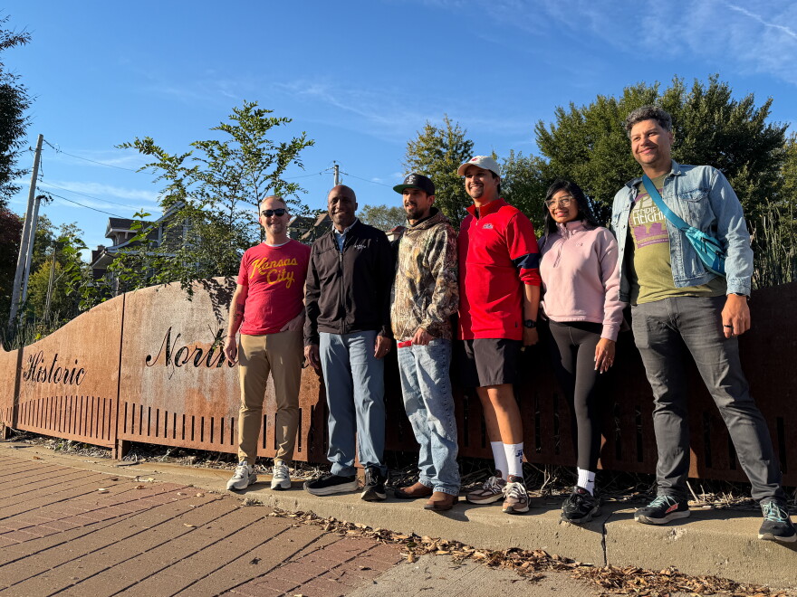 Mayor Quinton Lucas poses with Kansas City residents in front of a sign that reads, "Historic Northeast."
