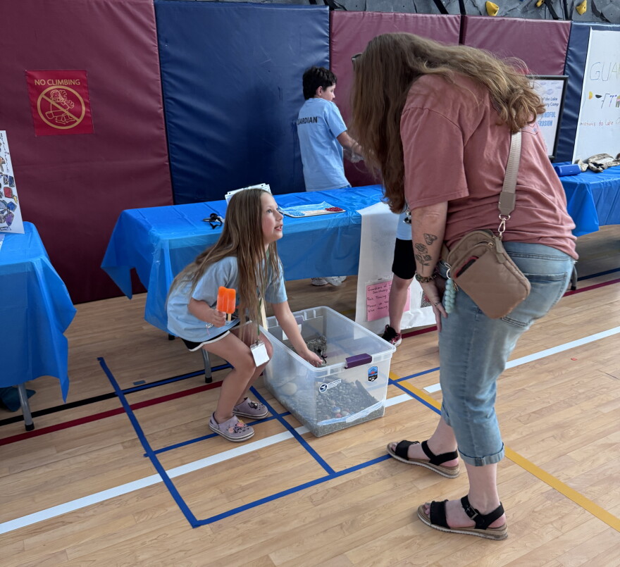 One student shows part of her class project during a student showcase on the last day of the Guardians of Lake Ontario summer camp held at CiTi BOCES.