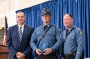 Keaton Siebenaler, center, receives the Colonel C.E. "Mel" Fisher award from the Missouri State Highway Patrol, in this photo with Gov. Mike Kehoe, left, and MSHP Superintendent Col. Michael Turner, right.