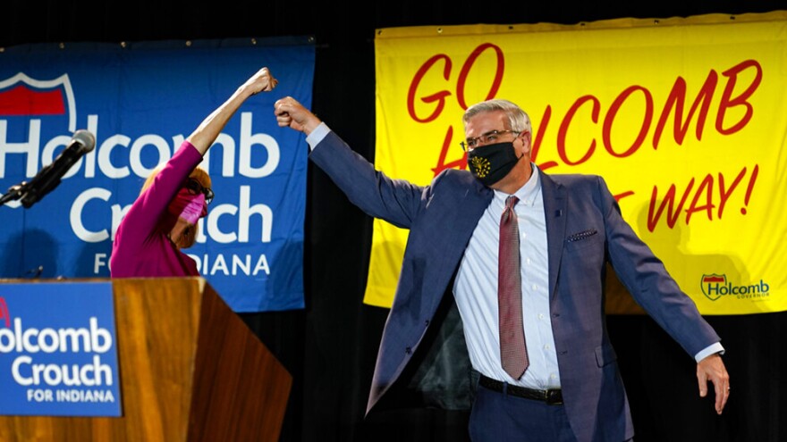 Indiana Gov. Eric Holcomb gets a high five from Lt. Gov. Suzanne Crouch after he addressed supporters after winning his second term as governor in Indianapolis, Tuesday, Nov. 3, 2020.