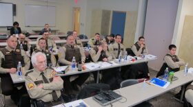 Officers sit in a meeting room