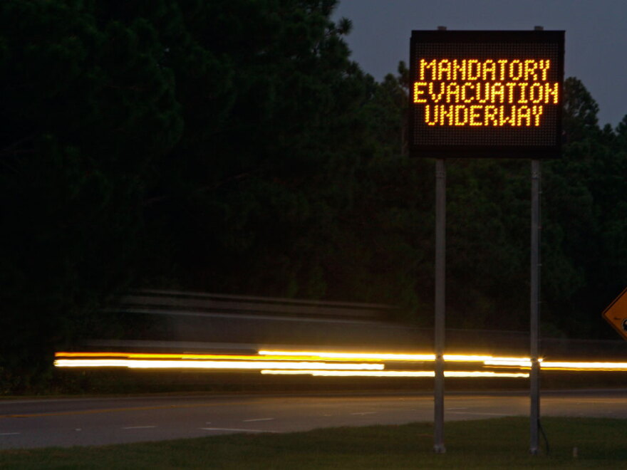 Cars stream past an evacuation message for Hatteras Island at the entrance to the Cape Hatteras National Seashore in Nags Head, N.C. A mandatory evacuation of visitors and residents is under way as Hurricane  Earl approaches.