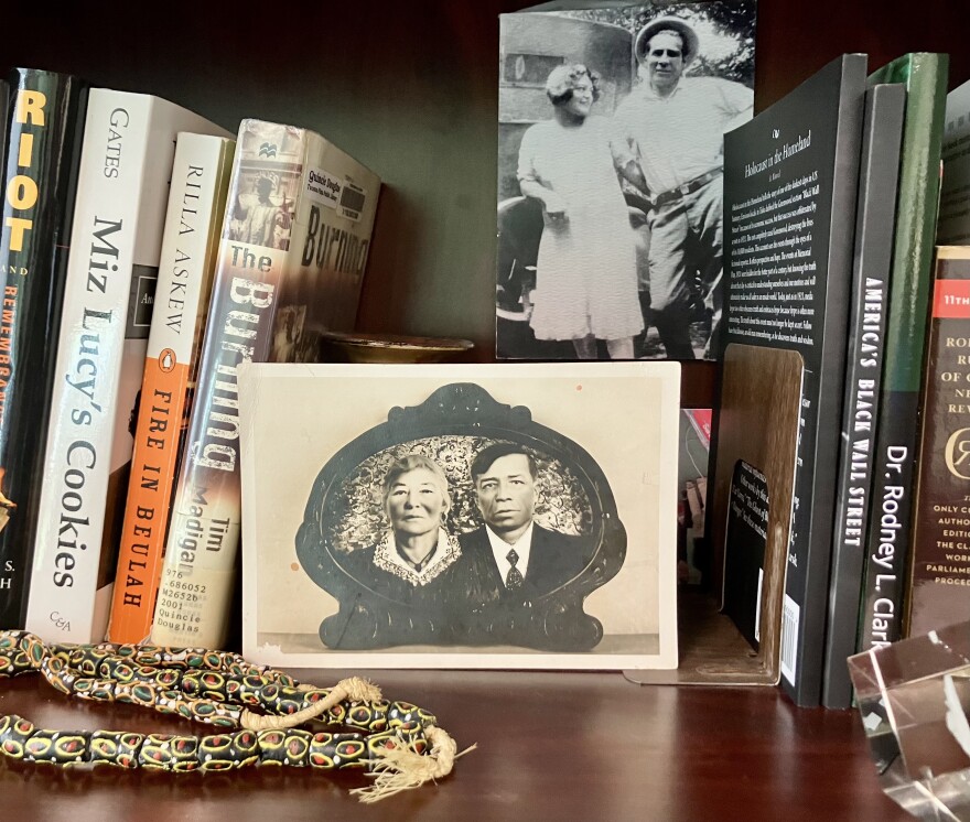 Michelle Burdex's bookshelf at the Greenwood Cultural Center holds photographs of her family.