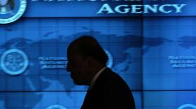 Then-Director of National Intelligence John Negroponte walks the hallways of the Threat Operations Center inside the National Security Agency in 2006.