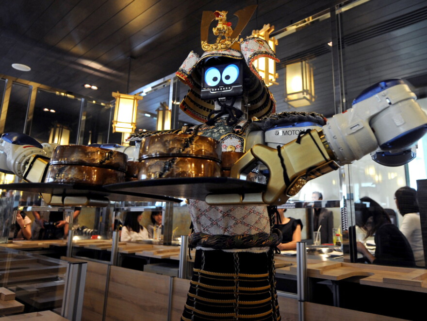 Are robot waiters in our future in the U.S.? Here, a robot holds a tray of food at a restaurant in Bangkok.