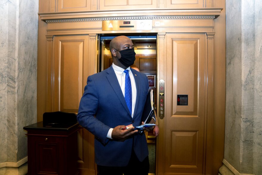 FILE - In this Feb. 13, 2021, file photo, Sen. Tim Scott, R-S.C., departs Capitol Hill in Washington. Scott will deliver Republicans’ rebuttal to President Joe Biden’s joint address to Congress. (Stefani Reynolds/Pool via AP, File)